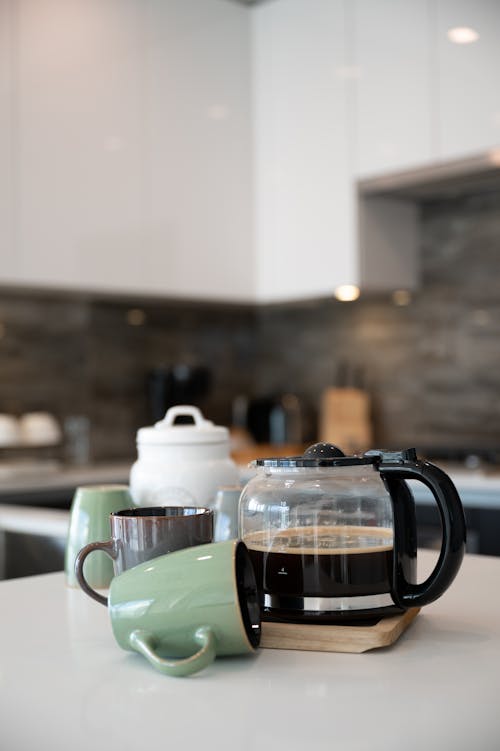 Close-up Photo of Mugs and Cups on a Counter Top 