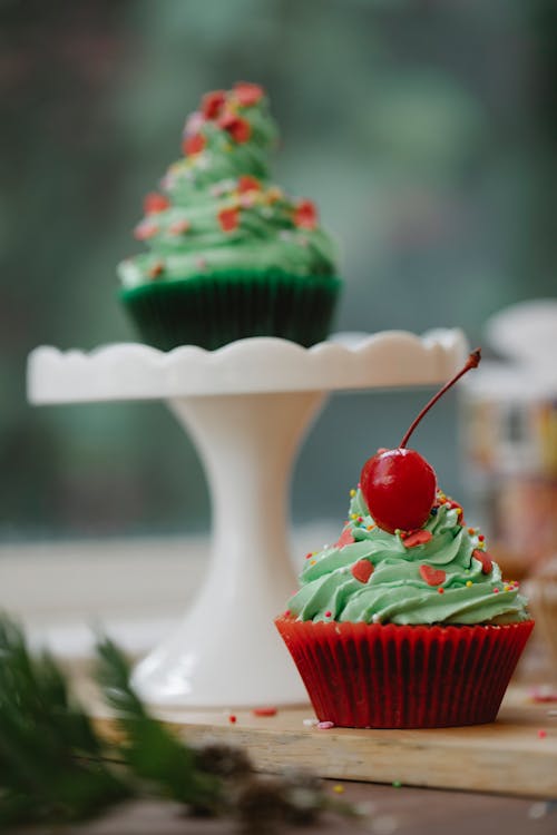 Sweet cupcake with red cherry on table
