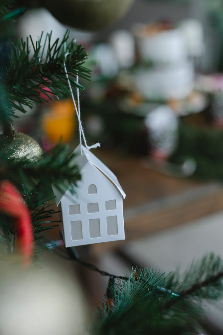 Christmas Tree With Small Carton House Toy And Garland