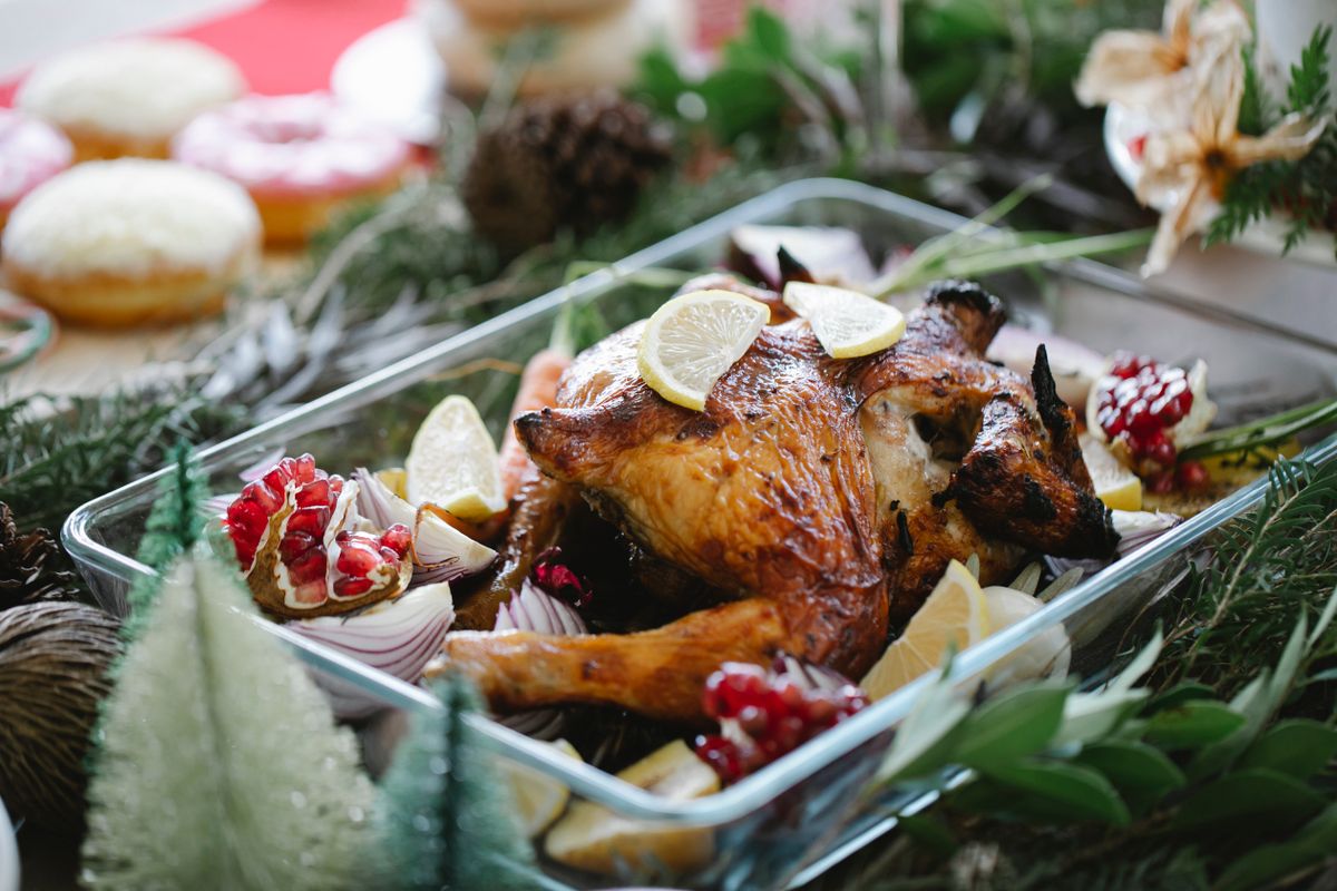Turkey in a baking dish with lemon and pomegranate