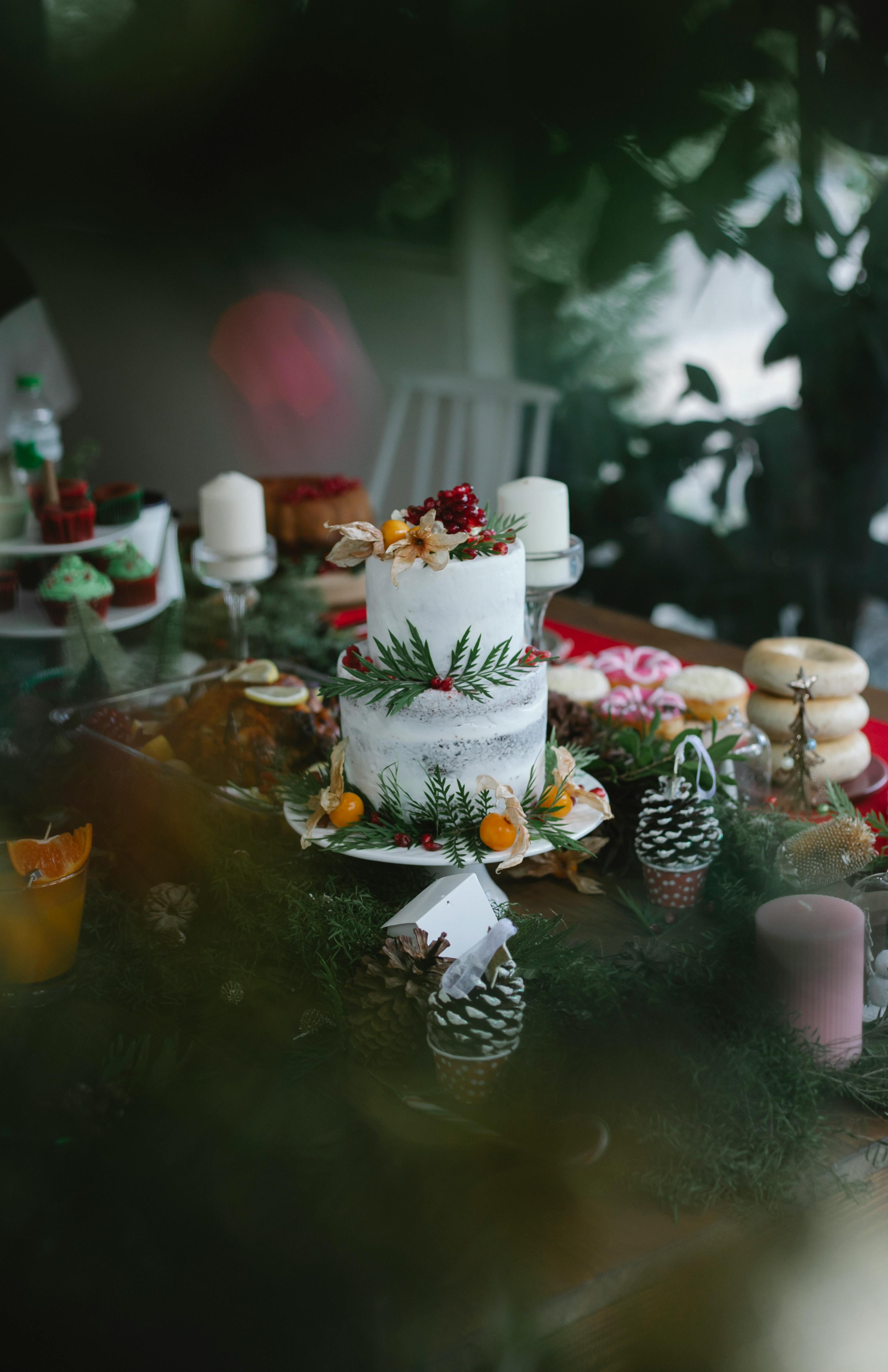 christmas table with cake and berries with leaves