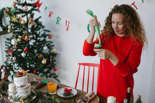 Woman decorating cupcakes for Christmas beside a beautifully adorned tree indoors.