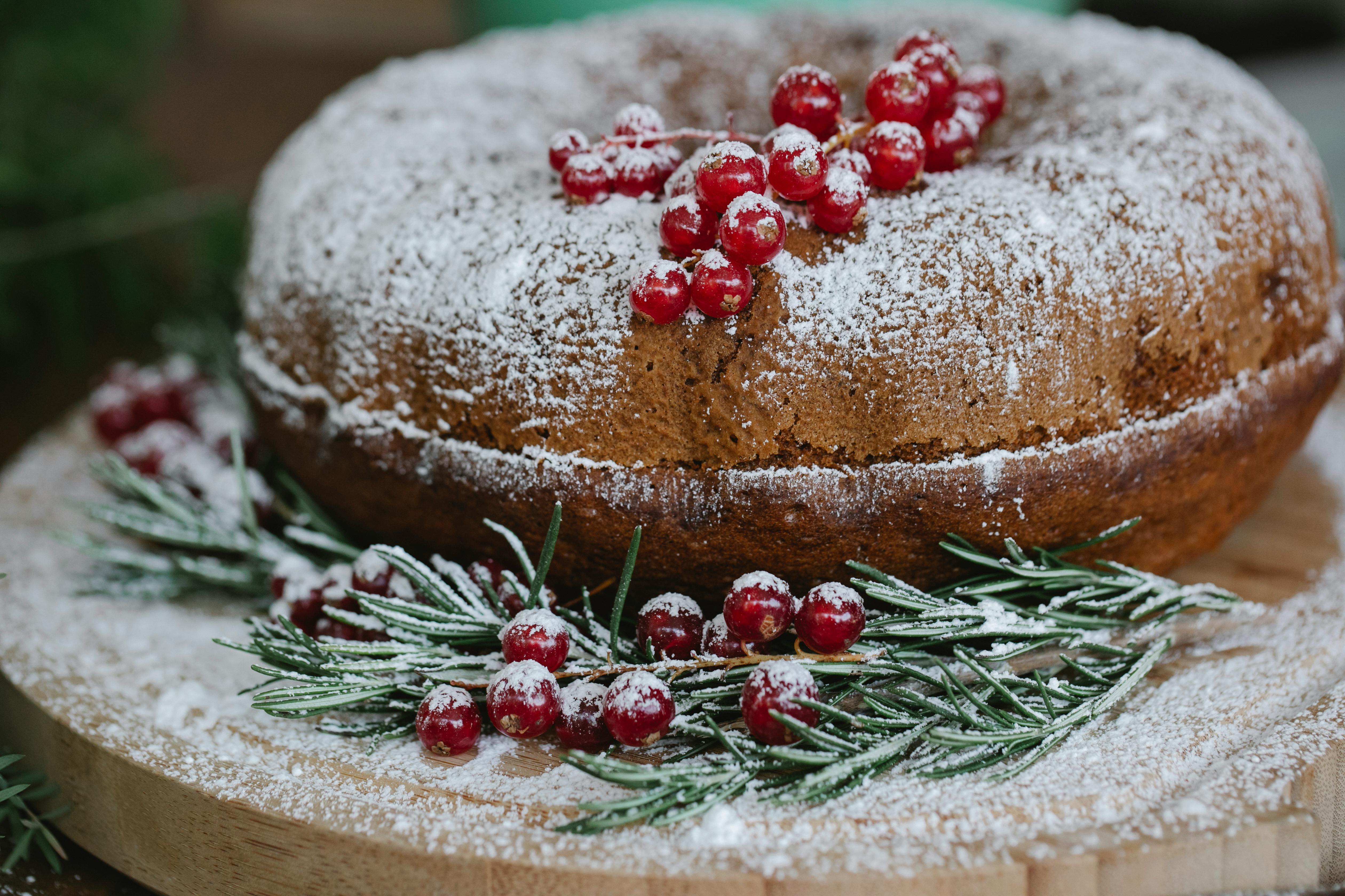 appetizing cake with red currants near spruce sprigs on tray