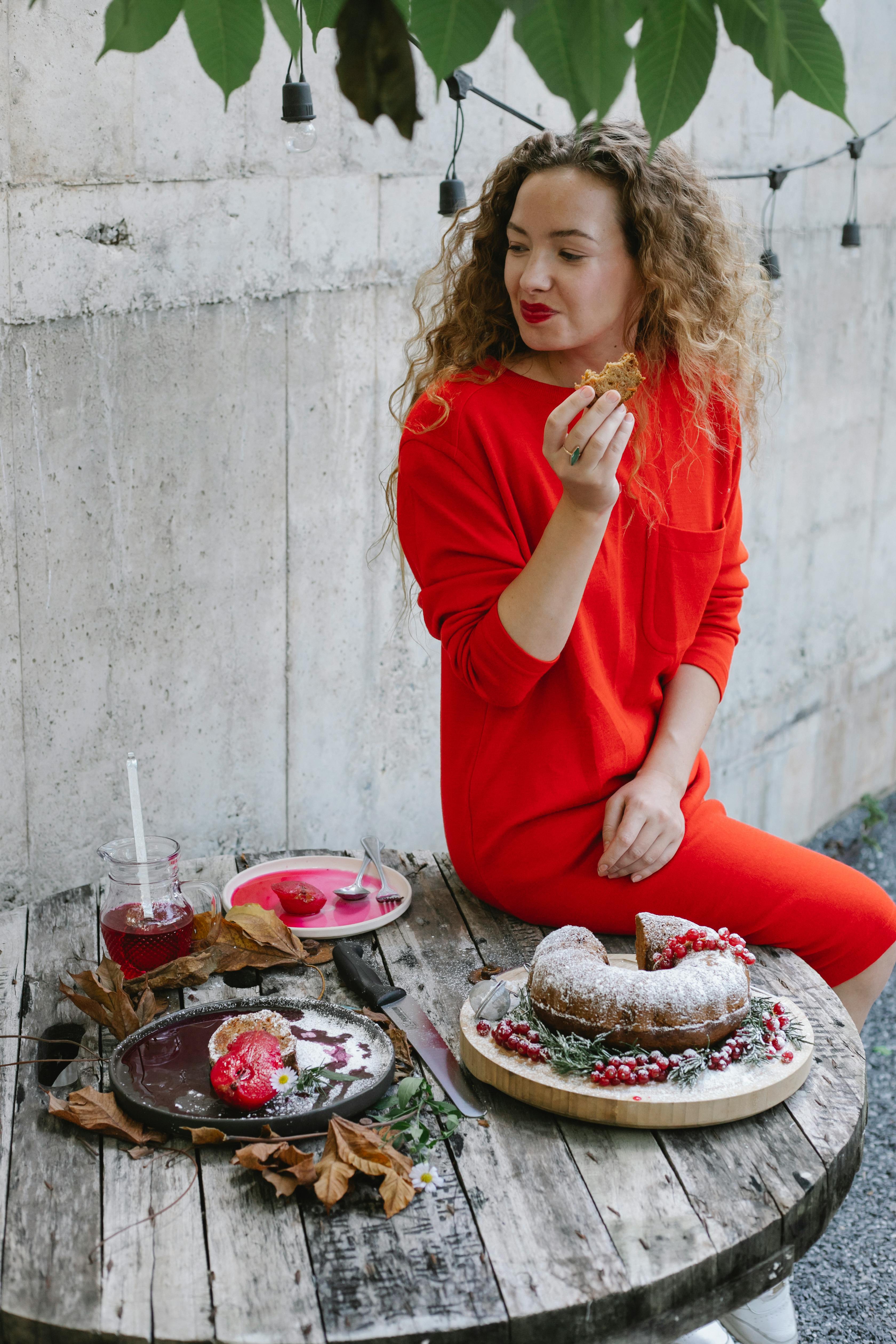 happy young woman eating delicious pie on backyard