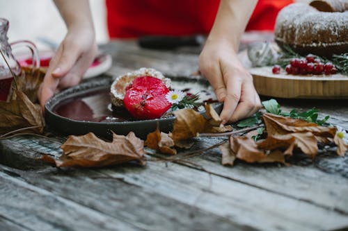 Crop unrecognizable woman serving scrumptious pie on wooden table