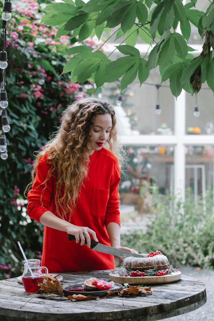 Content Housewife Cutting Delicious Pie In Garden