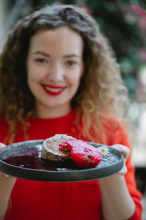 Woman demonstrating tasty sweet dessert