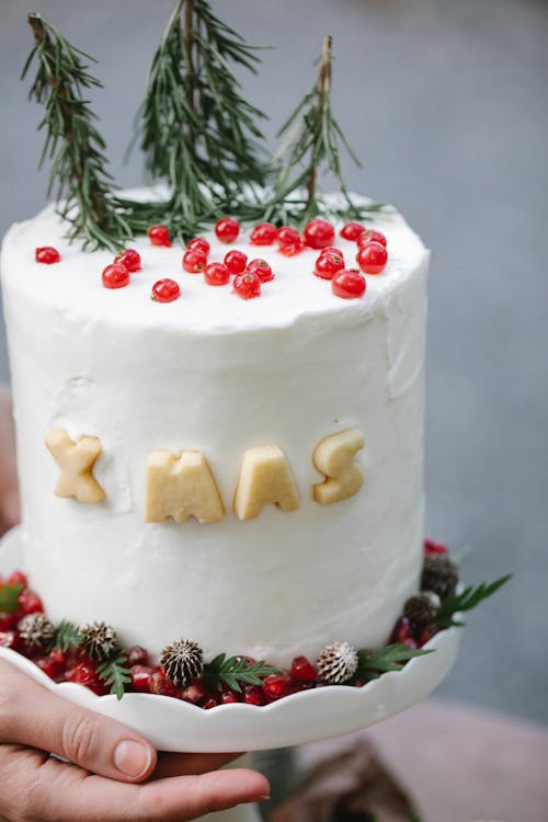Free Crop woman chef with decorated Christmas cake Stock Photo