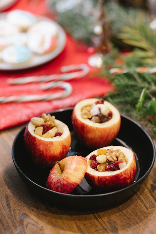 Delicious stuffed baked apples in baking dish on Christmas day