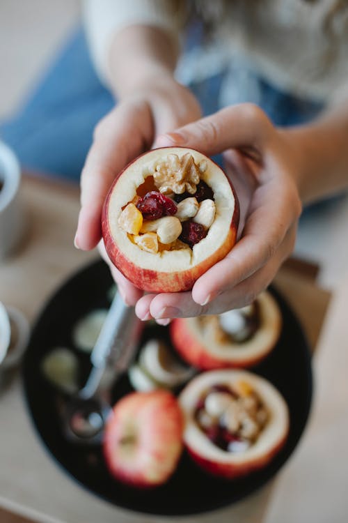 Crop chef showing delicious filled apple at home