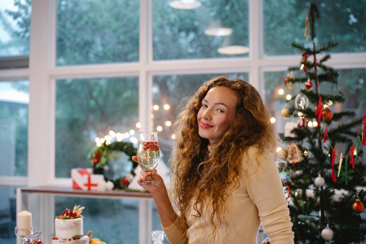 Smiling Woman With Champagne During New Year Holiday In House