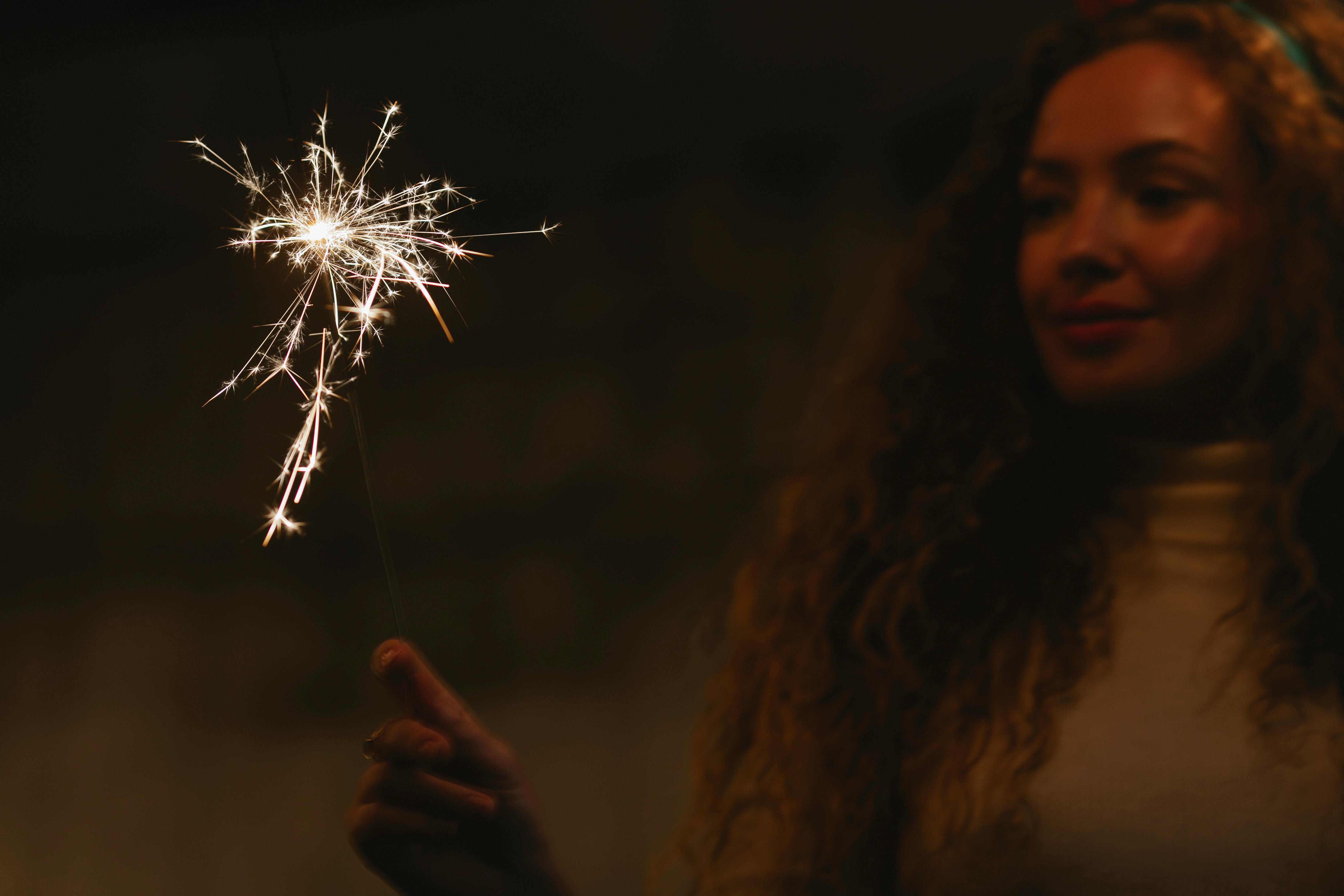 charming woman with shiny bengal light at night