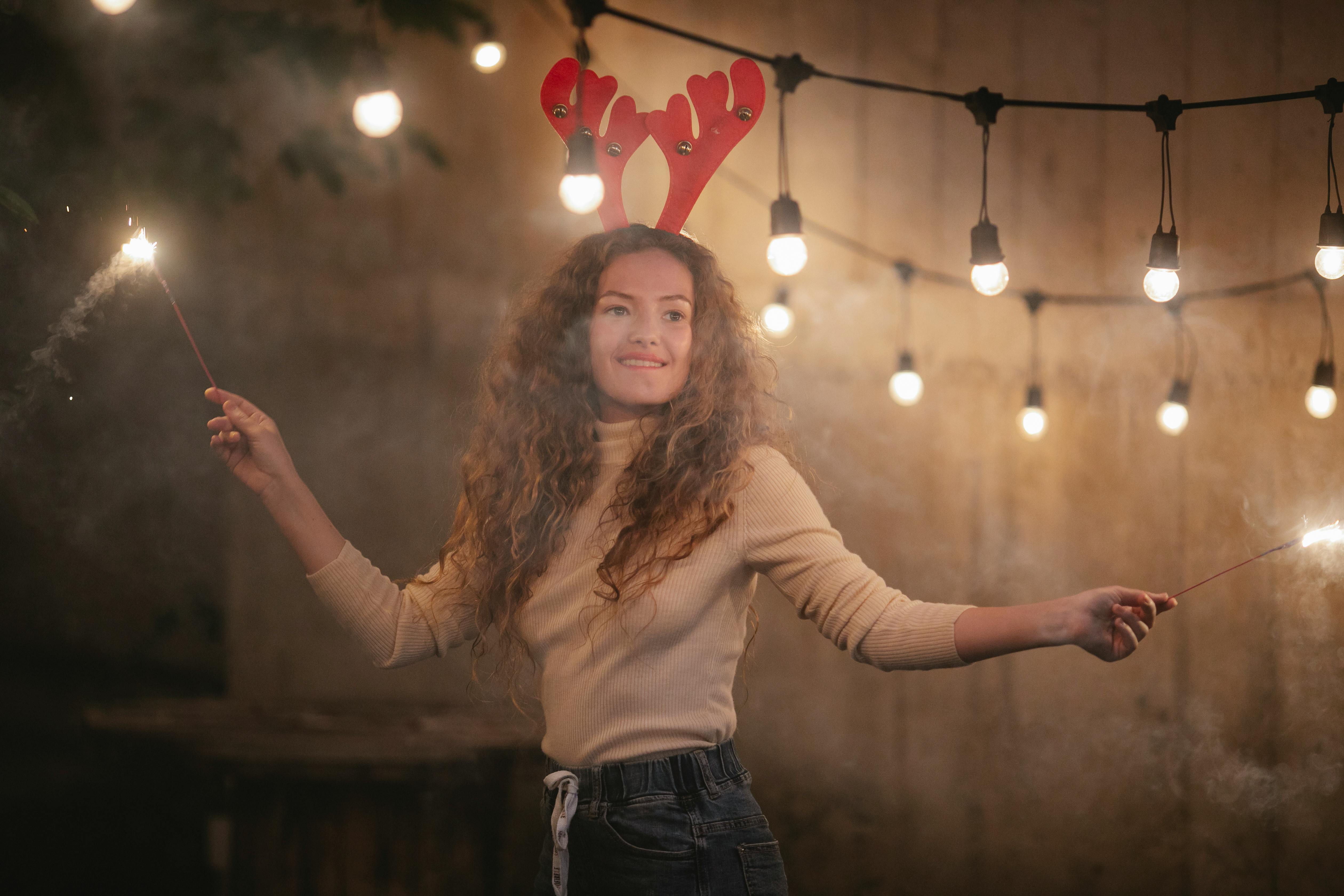 pondering woman with burning bengal lights celebrating christmas holiday