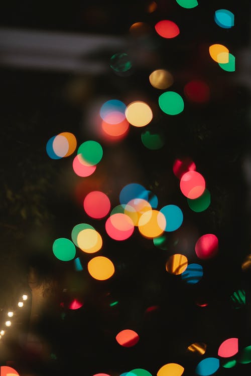 Free Bokeh Christmas background with multicolored lights at night Stock Photo