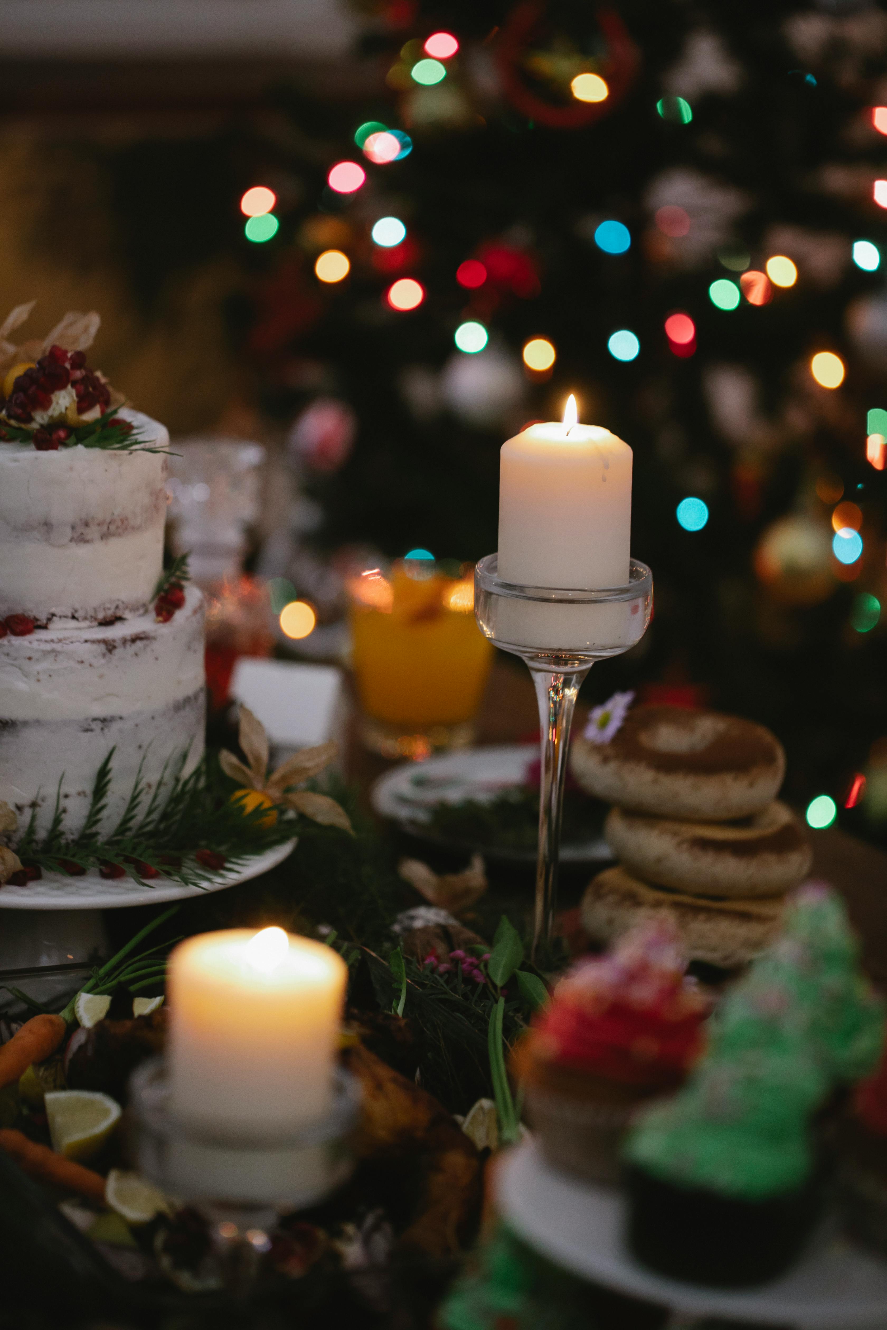 burning candles on table during christmas holiday at home