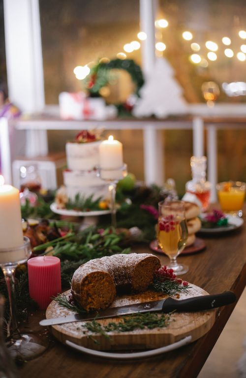 Free Tasty chocolate cake with icing sugar on cutting board with knife during Christmas holiday in house Stock Photo