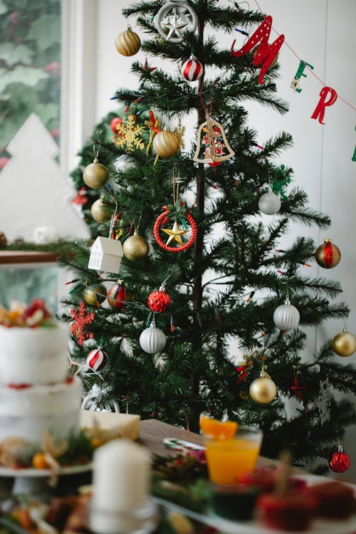 Decorated Christmas tree with baubles at home