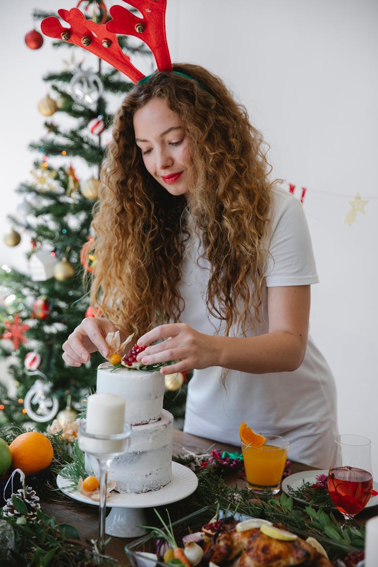 Woman Decorating Delicious Christmas Cake At Home