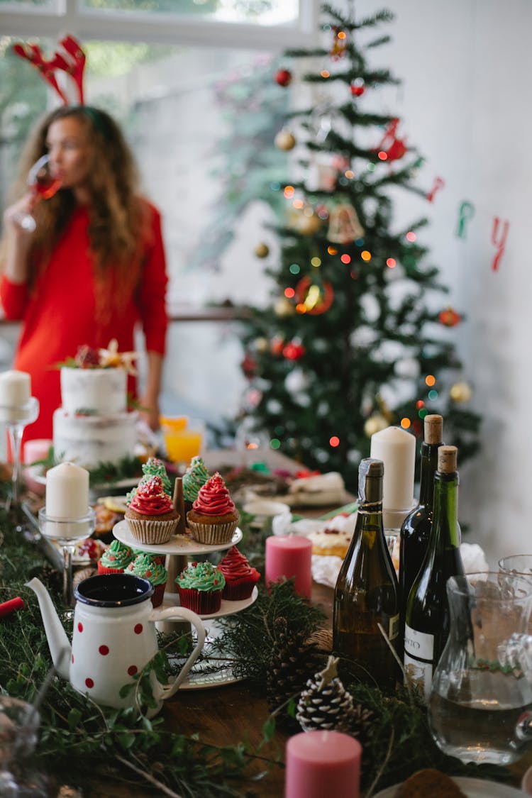 Woman Drinking Champagne Near Festive Christmas Tree