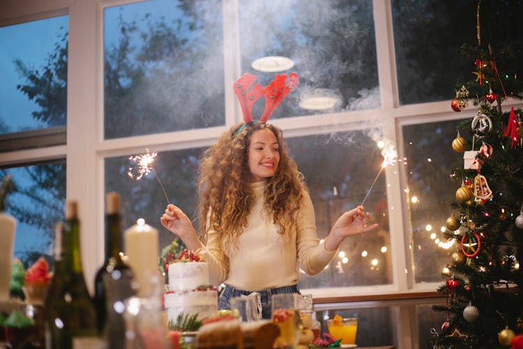 Happy Woman In Deer Antlers With Bengal Lights