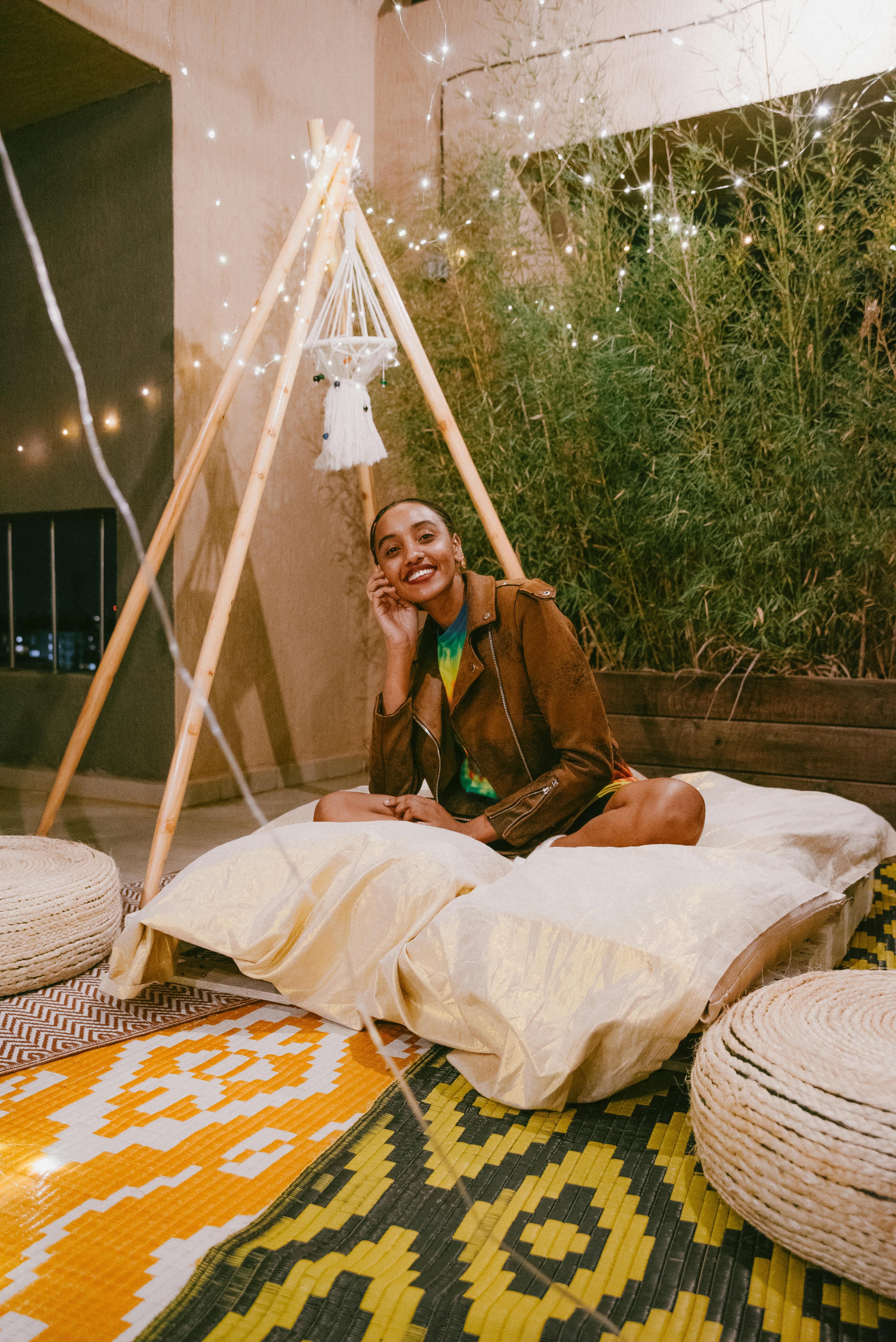 Portrait of Woman Sitting on Pillows · Free Stock Photo