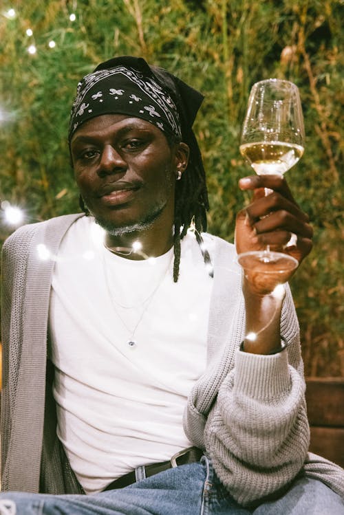 Free A Man in a Bandana Holding a Glass of Wine Stock Photo