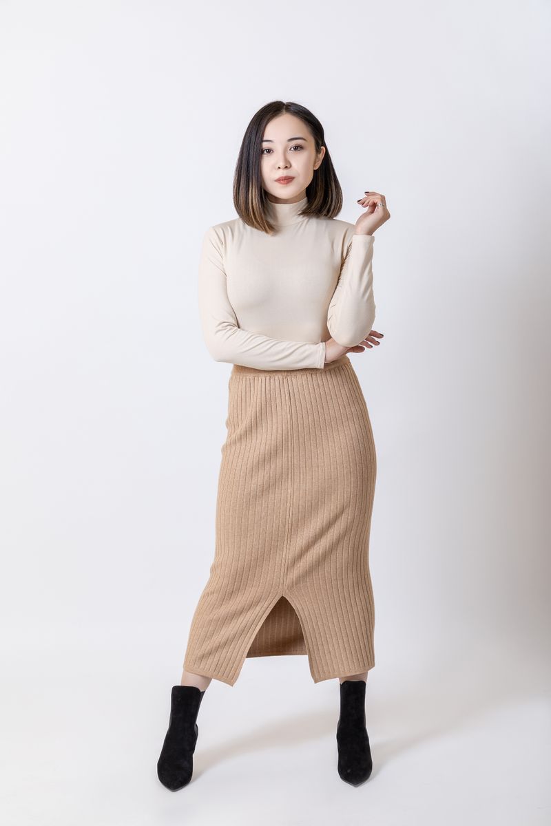 woman in a cardigan layered over a dress