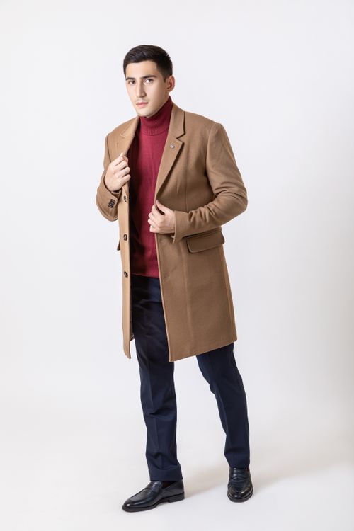 Free Elegant man in a camel coat with dark hair against a white background, showcasing fashion style. Stock Photo