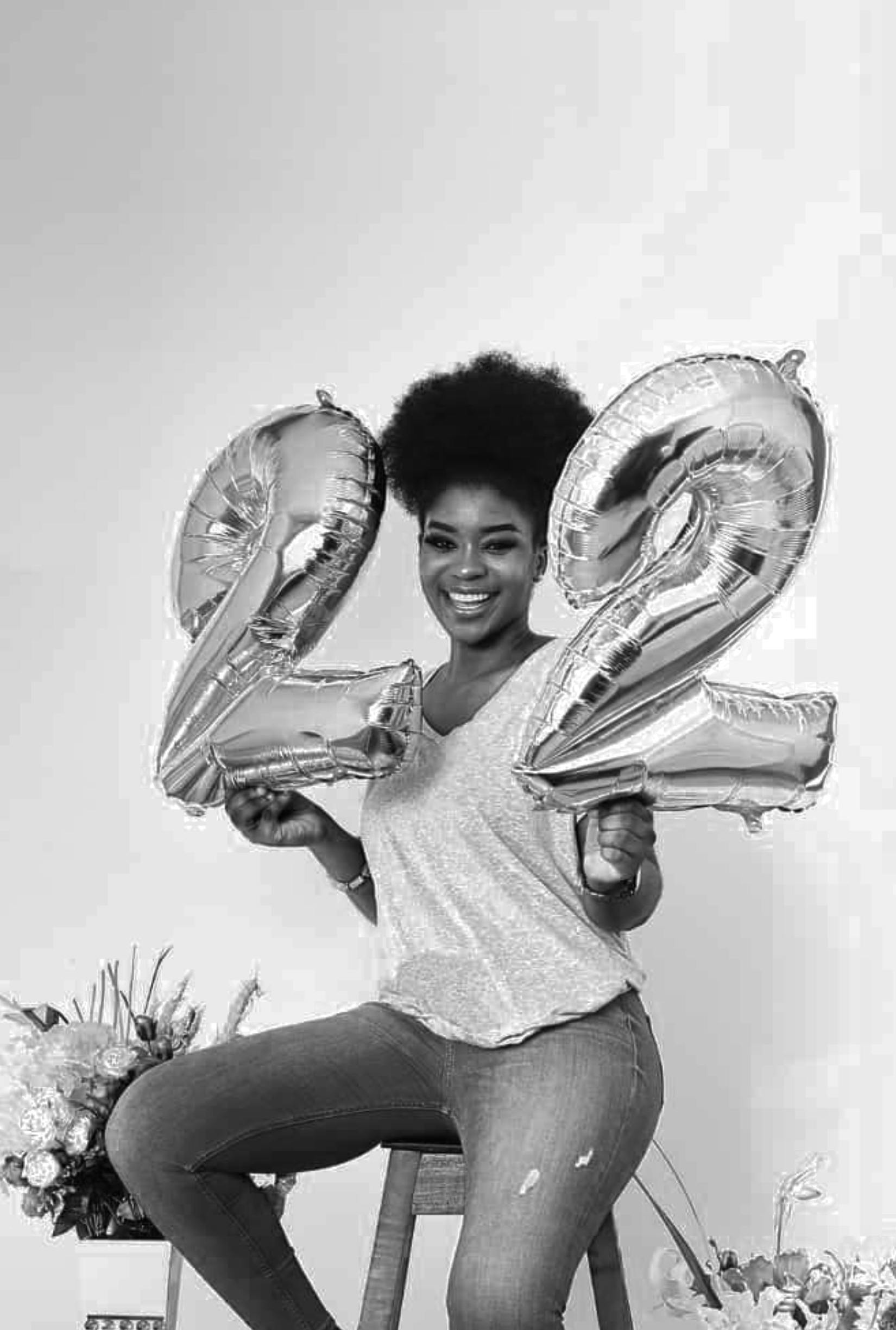 portrait of a woman holding balloons