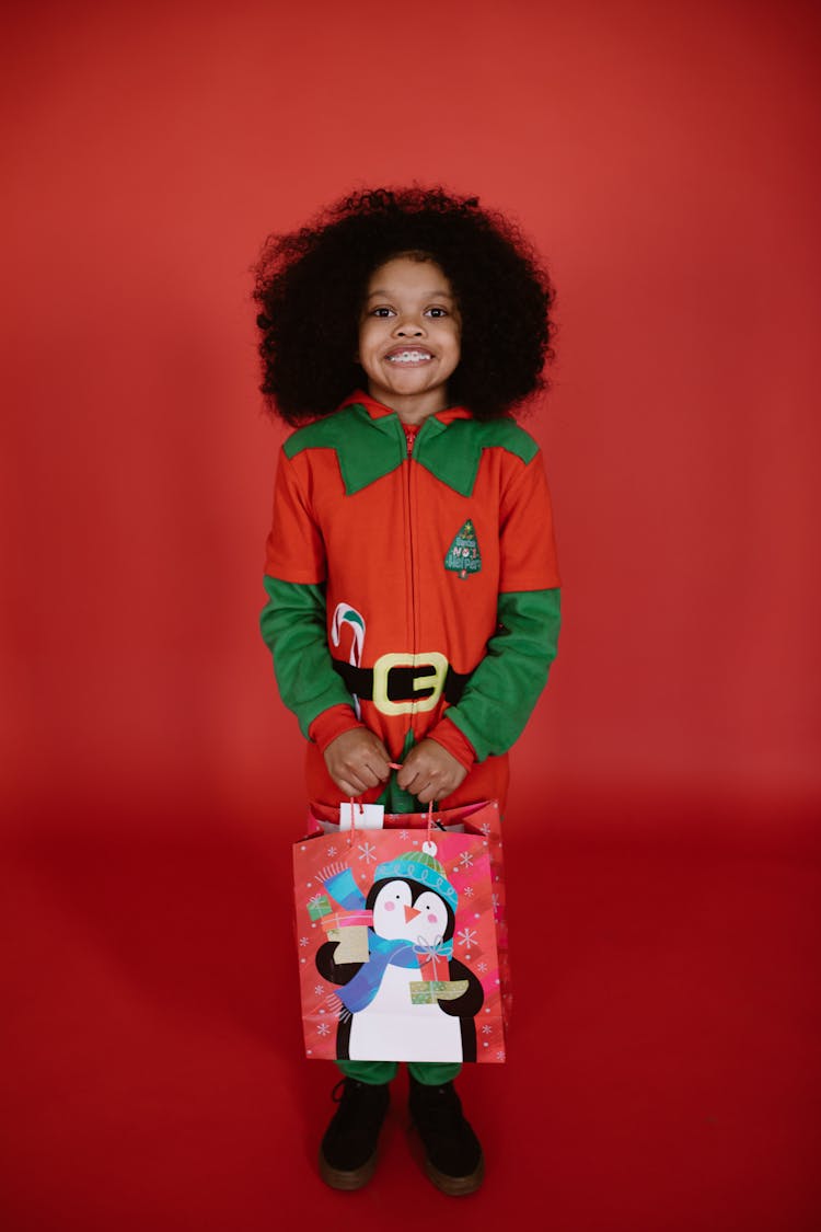 Boy Wearing Costume Holding A Paper Bag