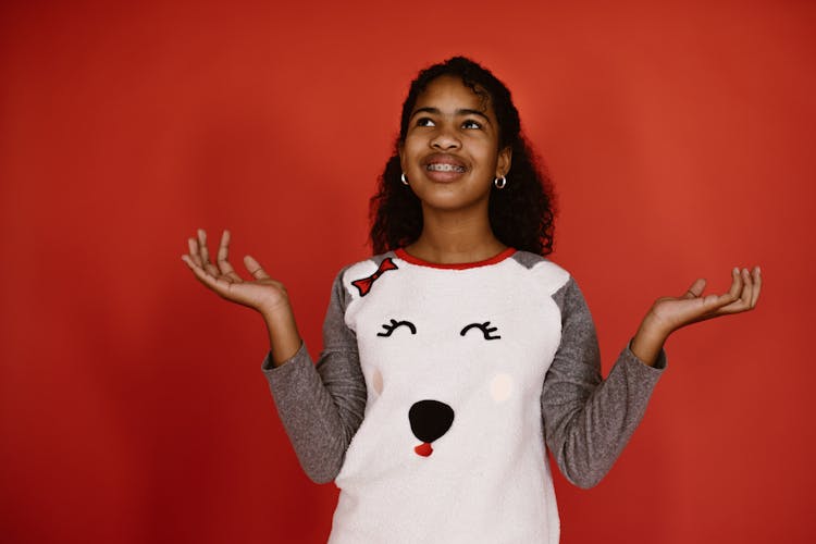 A Girl With Braces Smiling And Posing