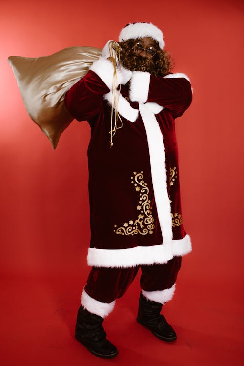 Man in a Santa Claus Costume Carrying a Sack