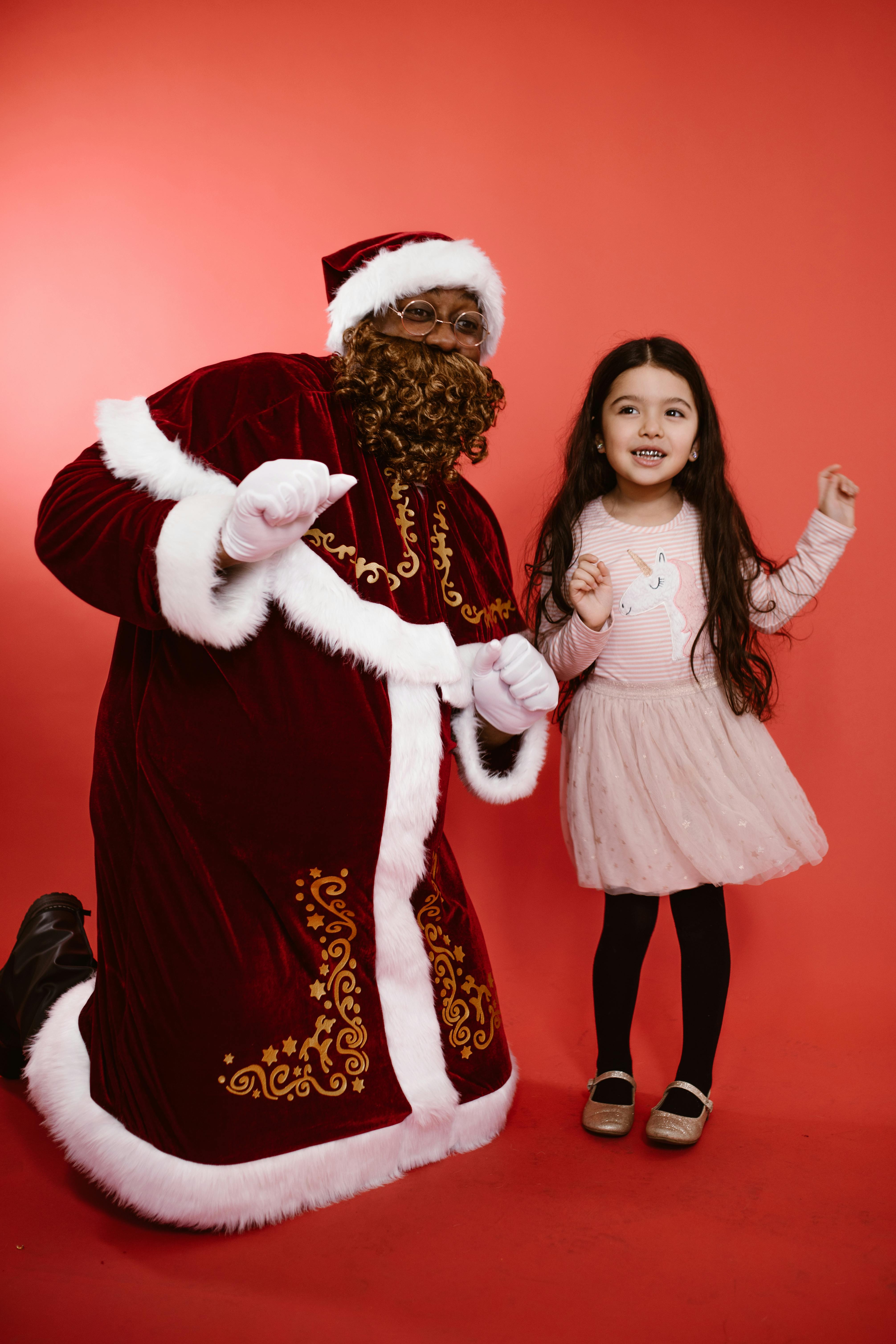 A Man in a Santa Costume and a Little Girl Dancing Together · Free Stock  Photo
