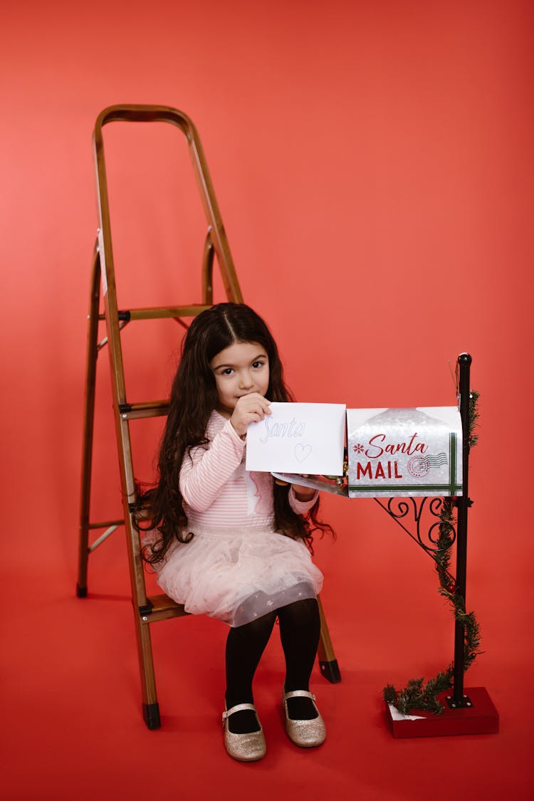 Girl Putting A Letter In A Mailbox