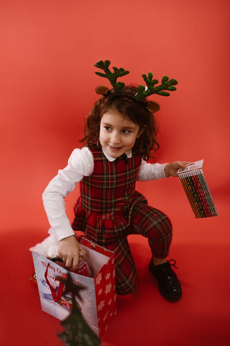 A Child Opening A Christmas Present