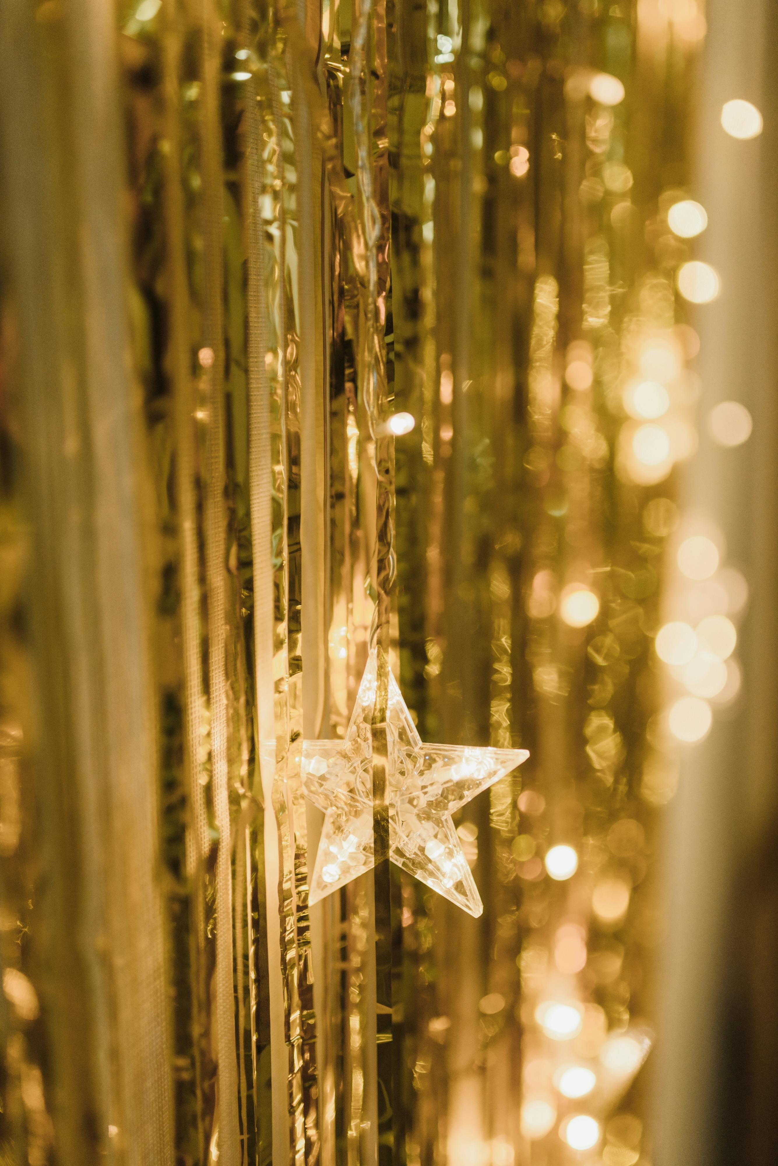 Bright star ornament amidst shimmering lights and golden decorations, perfect for festive occasions.