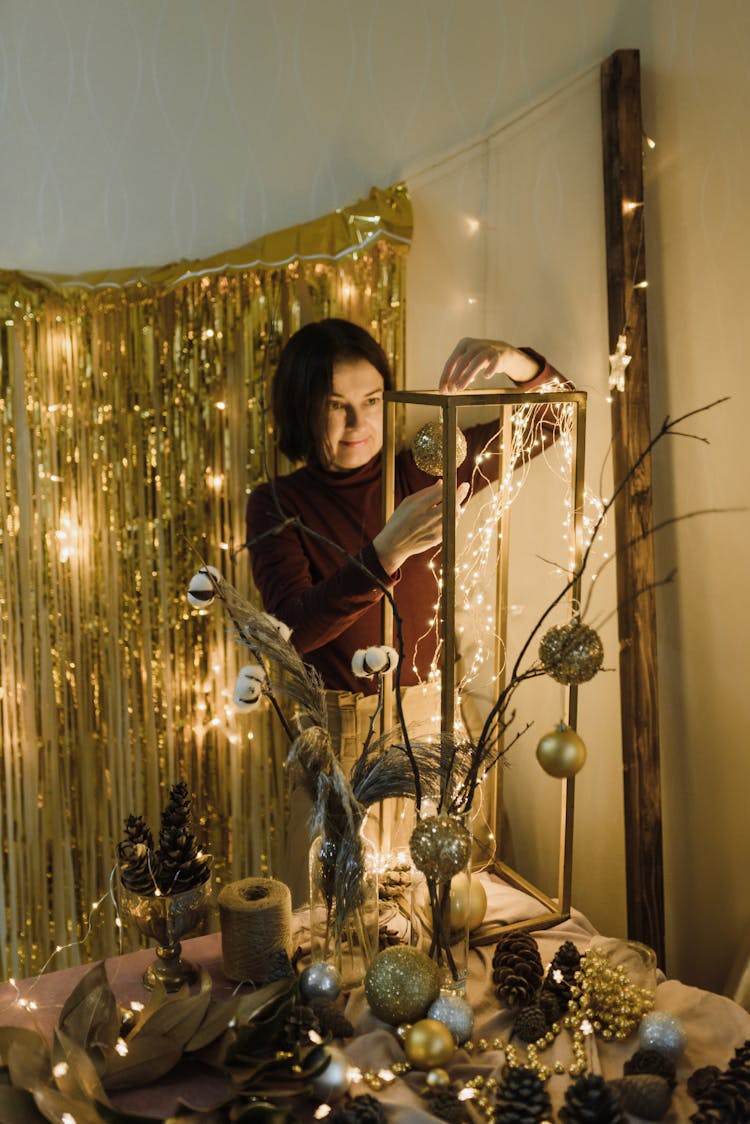 Woman Making Golden Christmas Decorations