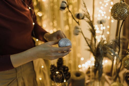 Woman with Glitter Bauble in Hands