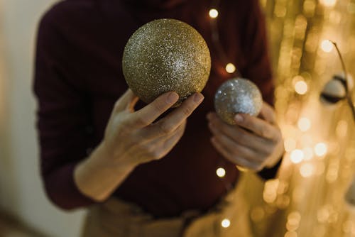 Close-up of a Woman Holding Glittery Baubles 