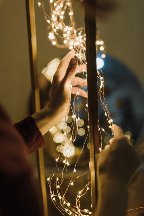 Close-up of Woman Decorating with Lights