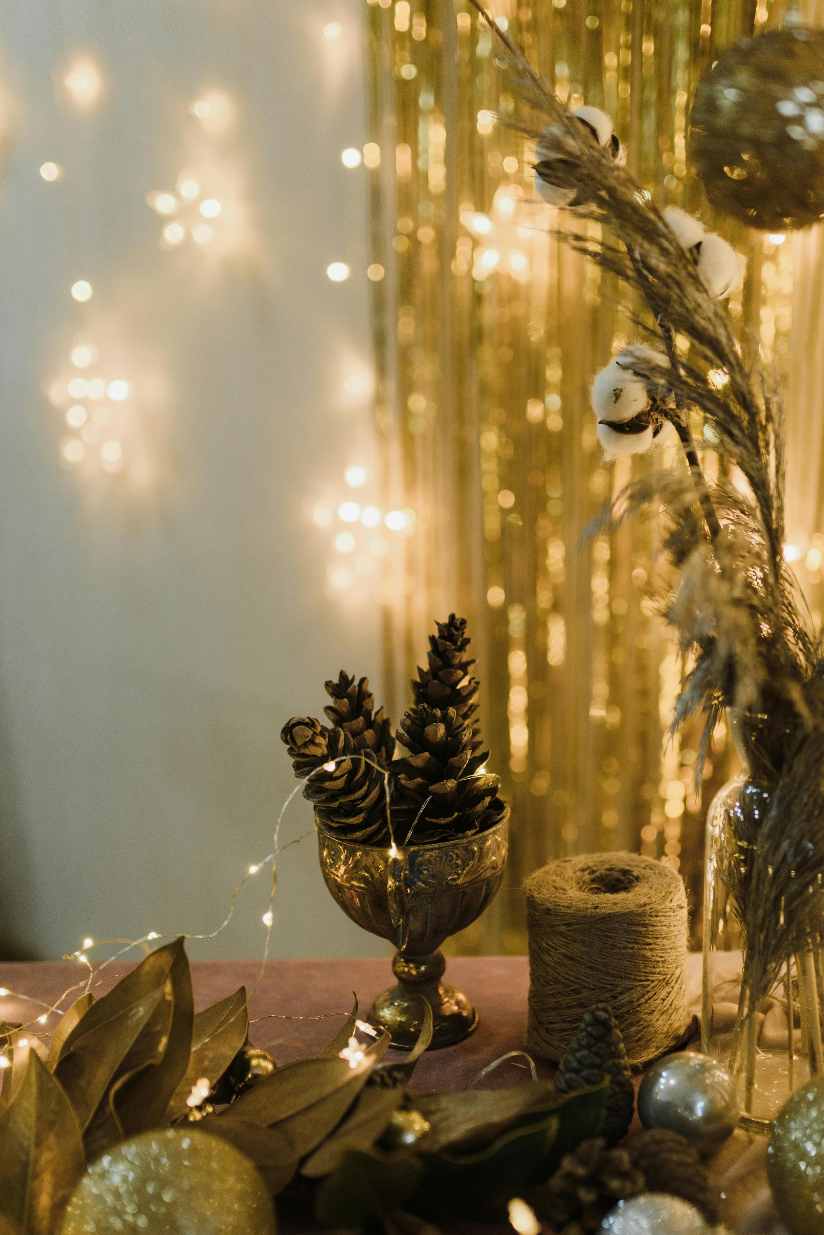 Elegant Christmas setup with pine cones, golden lights, and festive decorations adding a warm holiday atmosphere.