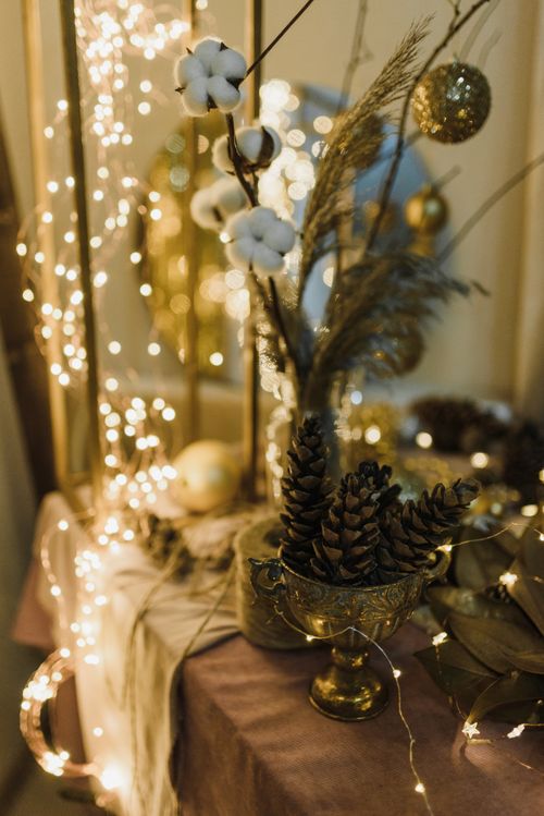 Free A festive display featuring pine cones, cotton, and twinkling lights in a cozy setting. Stock Photo