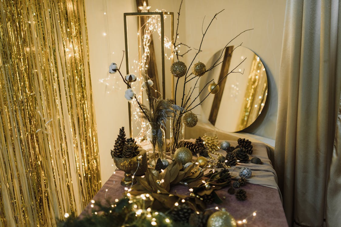 Gold and Silver Themed Christmas Decorations with Pine Cones on Table