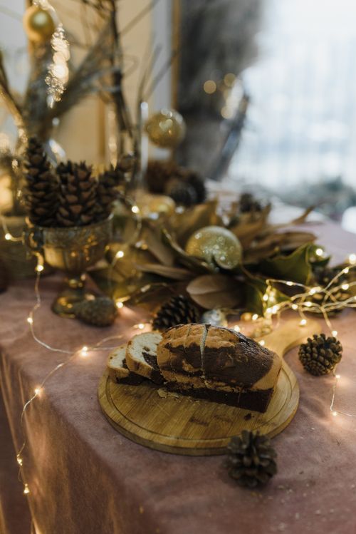 Free Cozy Christmas bread setting adorned with festive decorations and warm lighting. Stock Photo
