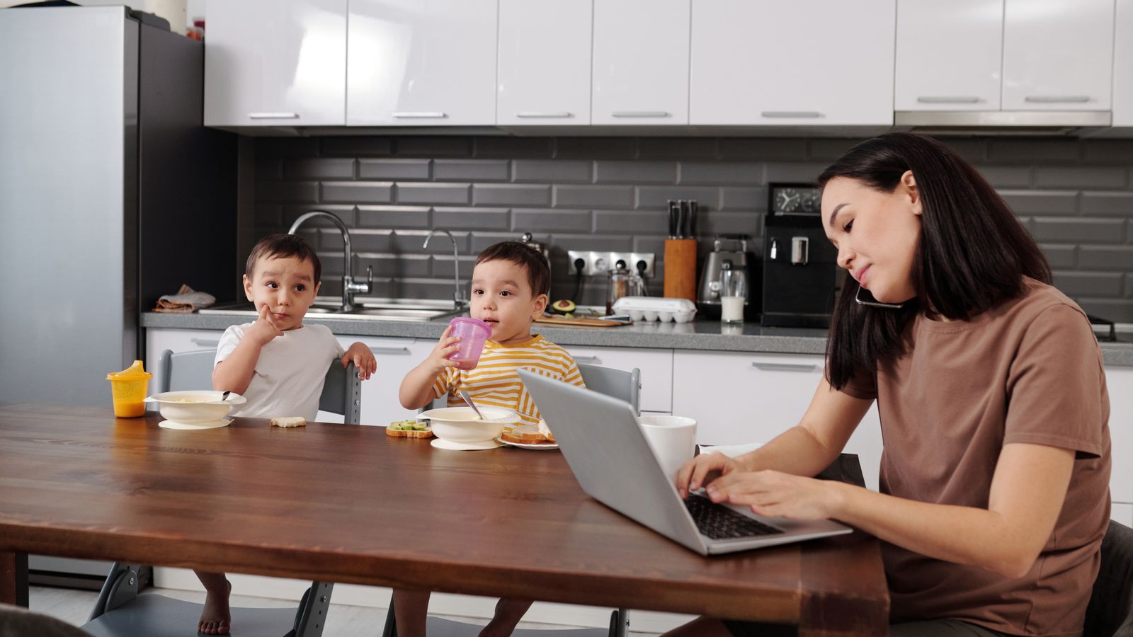 A tired parent multitasking at home