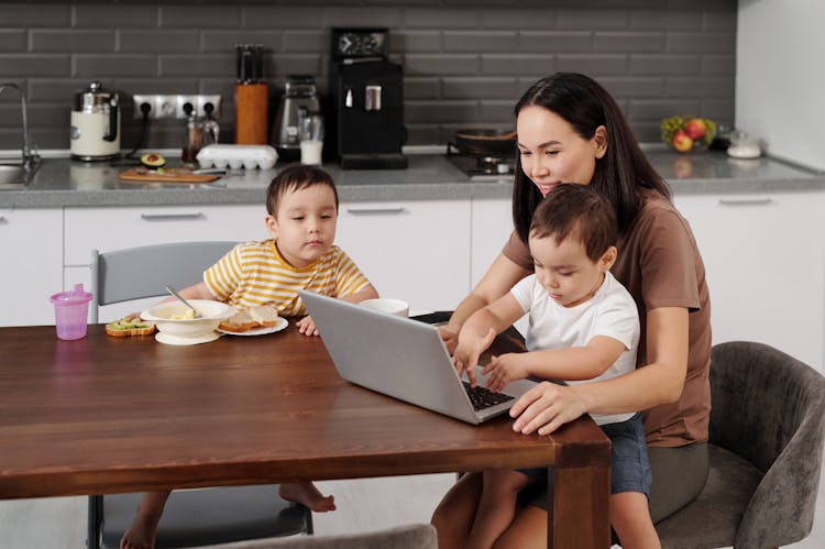 Woman With Sons In A Kitchen 