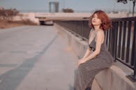 Young woman in elegant dress on pavement