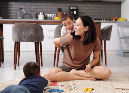 Free Mother and Her Children Playing at the Kitchen Stock Photo