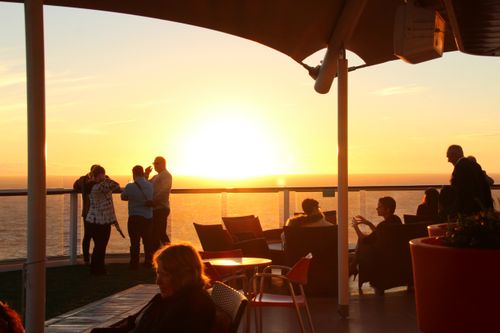 Free People enjoying a breathtaking ocean view during golden hour on a cruise ship deck. Stock Photo