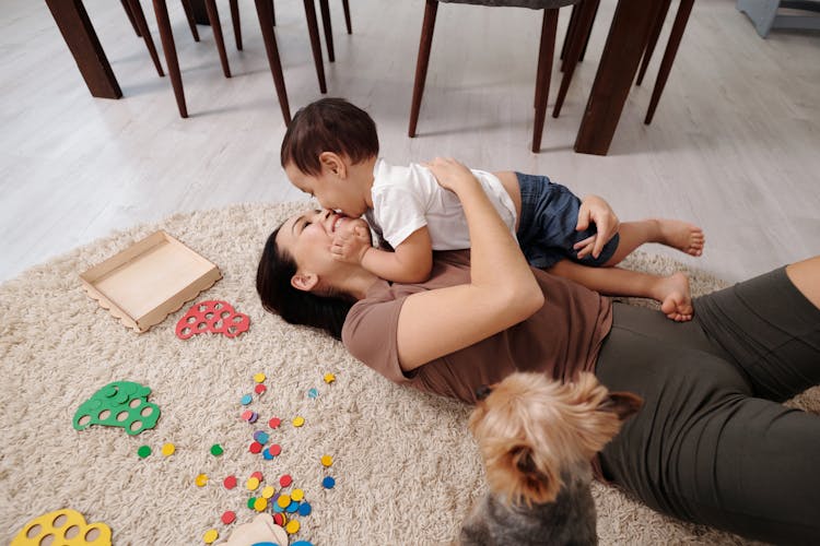 Mother Playing With Child Near The Dog